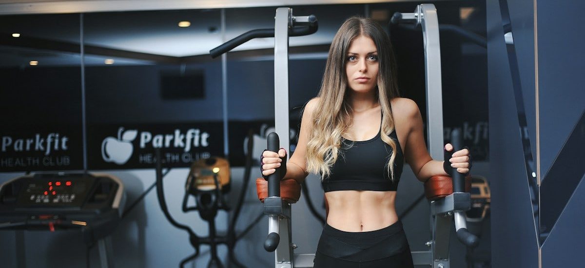 a woman in a black sports bra top and black leggings