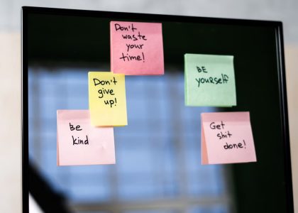 Colorful sticky notes on a mirror provide daily motivational messages and positivity reminders.